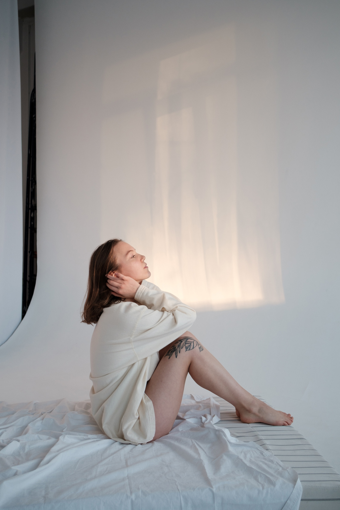 Barefoot female relaxing on mattress